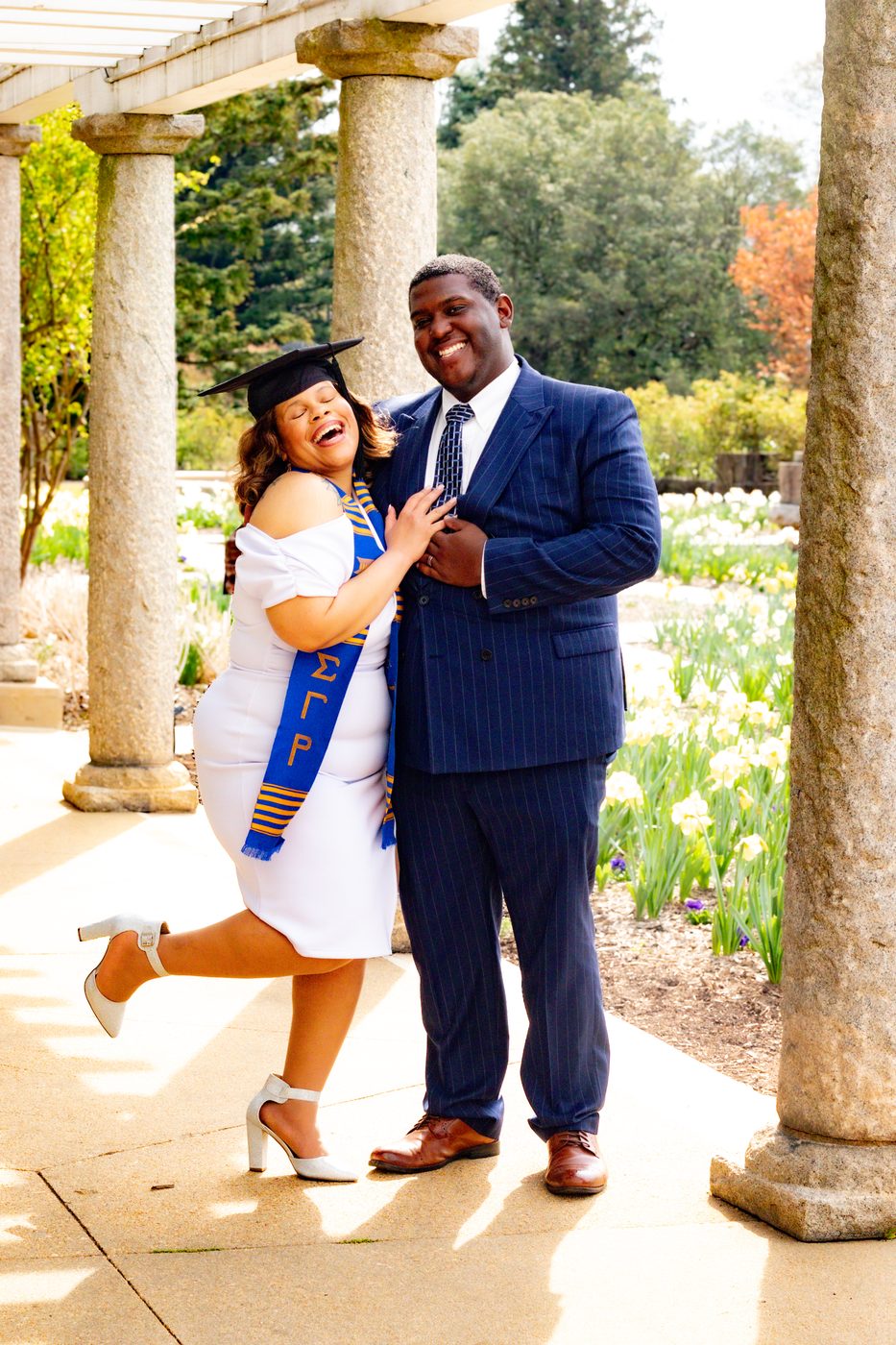 Graduation celebration portrait under stone columns