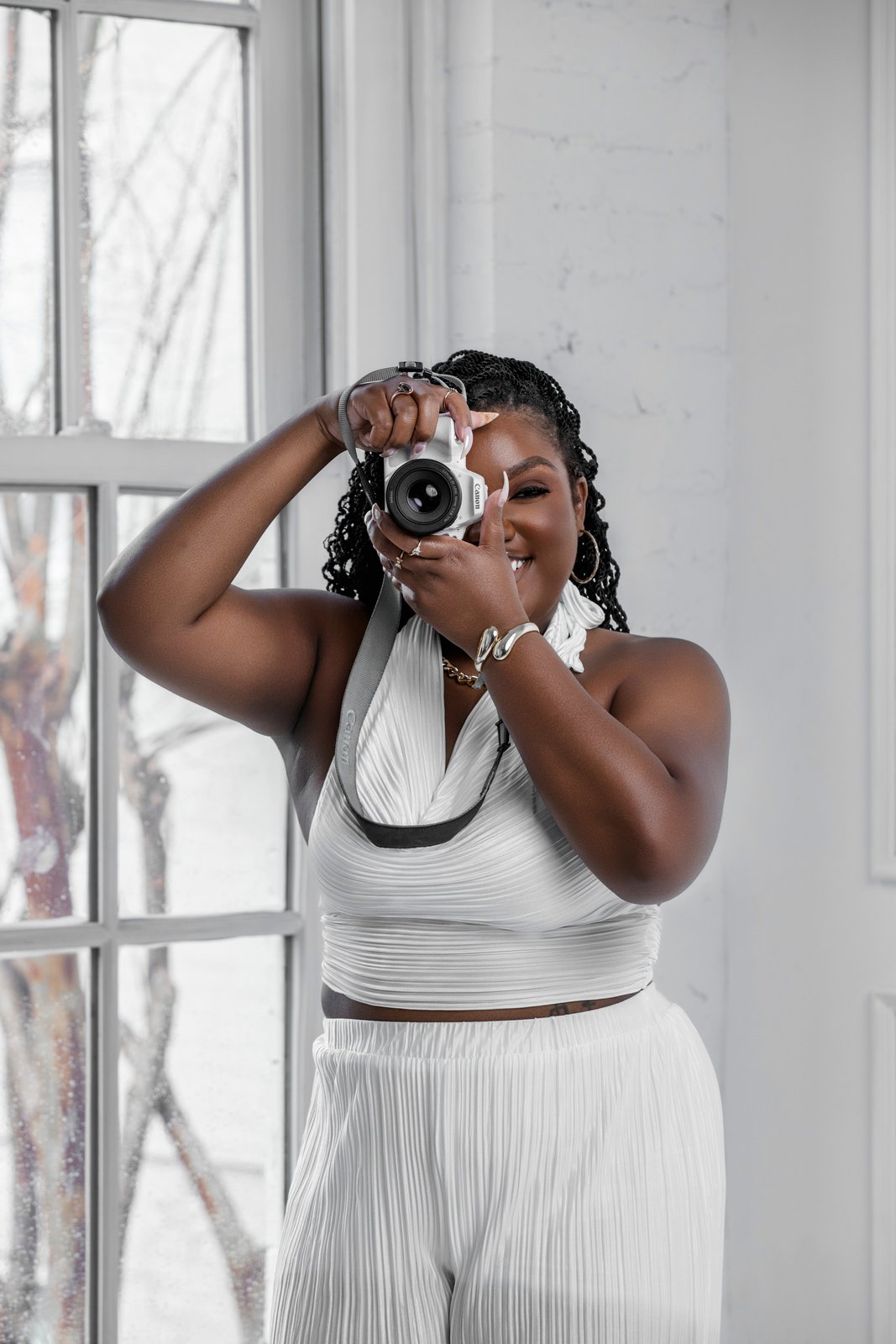 Patty Barham mid-shoot, camera raised to capture the moment